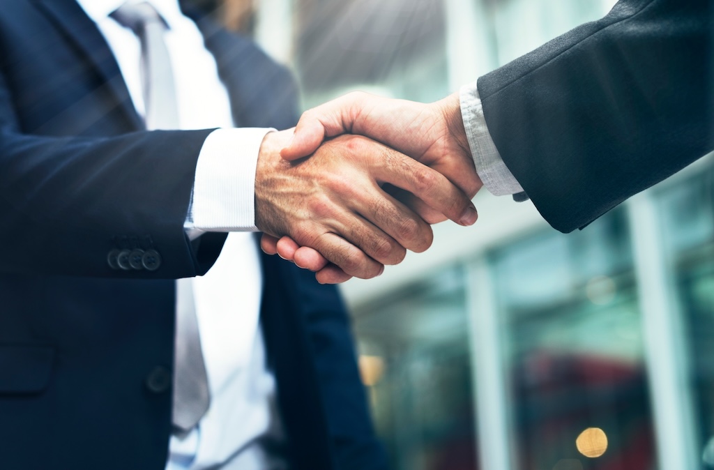 Business handshake sealing partnership